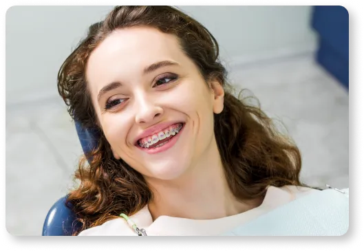 a smiling woman sitting in a blue chair